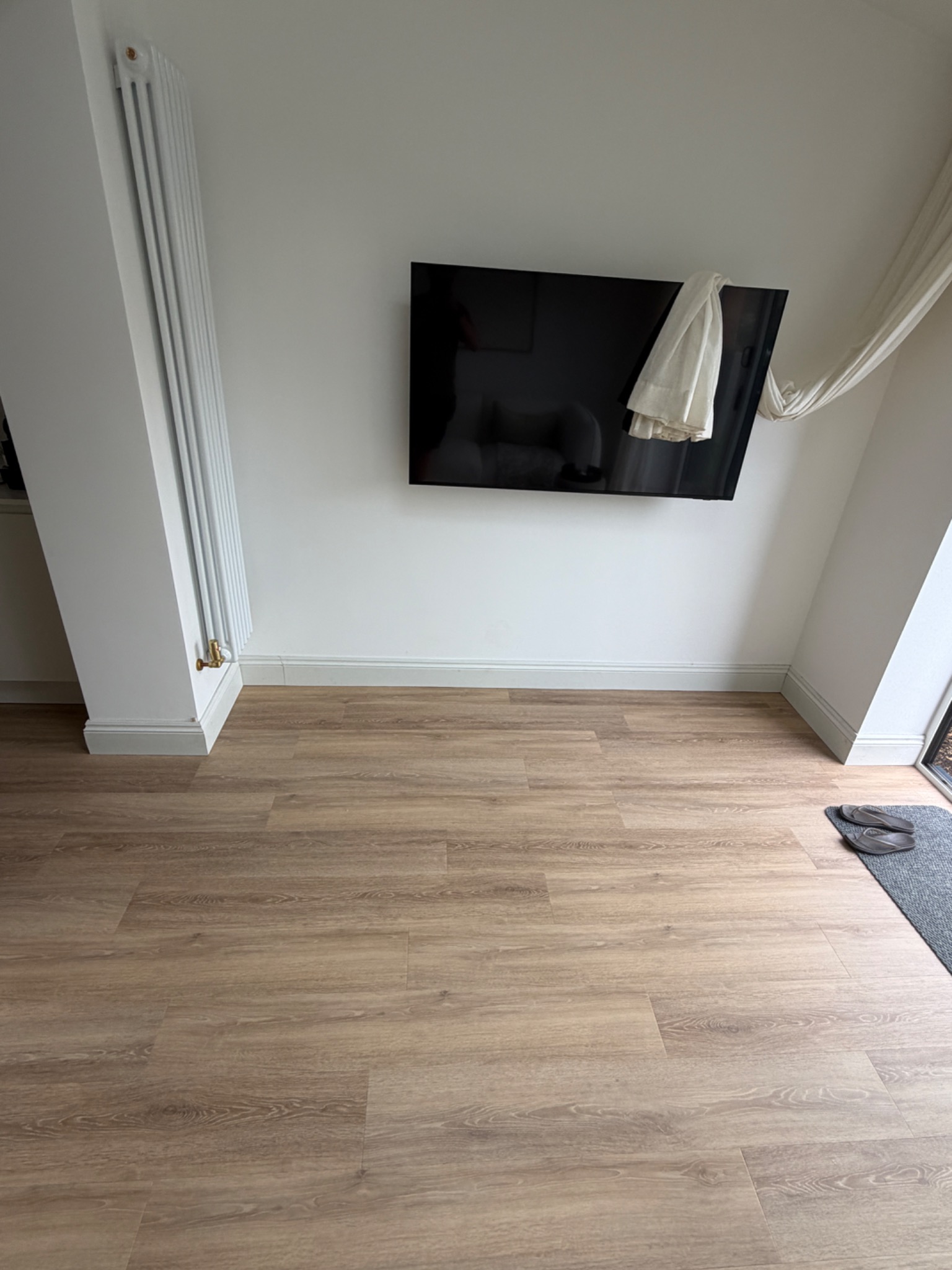 Finished skirting and flooring around a media wall